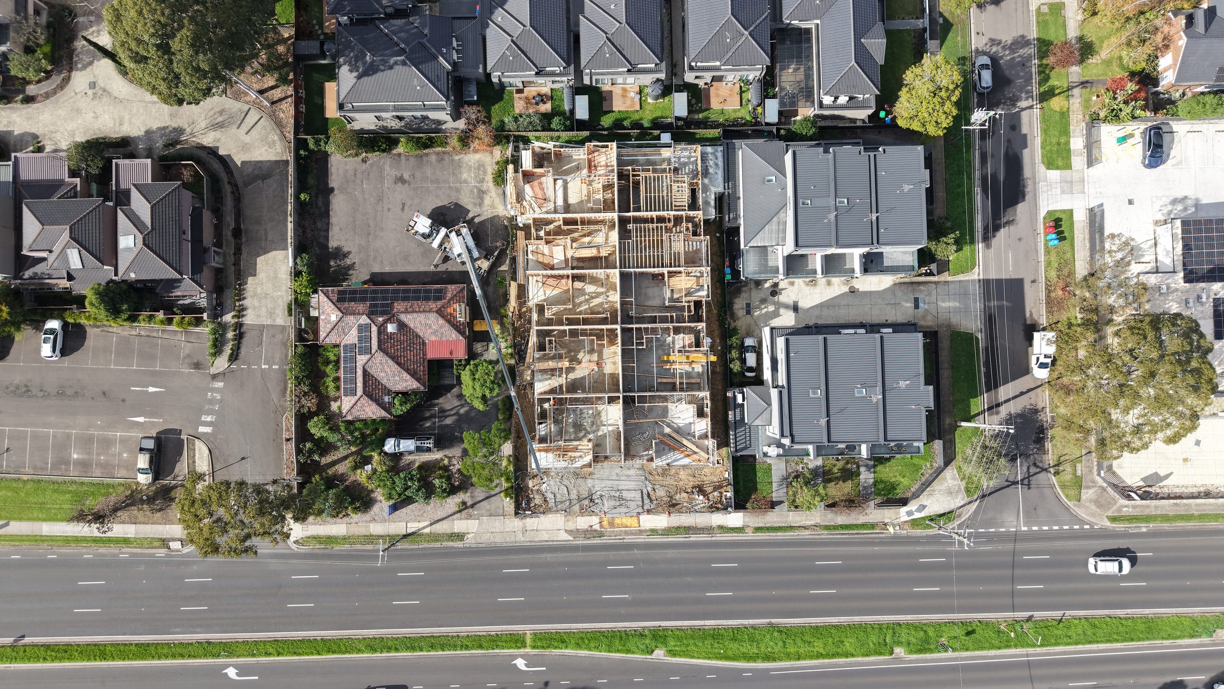 Aerial view of townhouse construction with crane